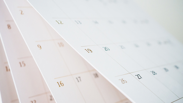 Calendar page flipping sheet close up with blurred background.